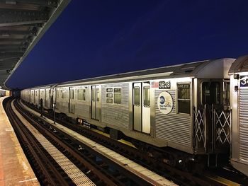 Train at railroad station against sky