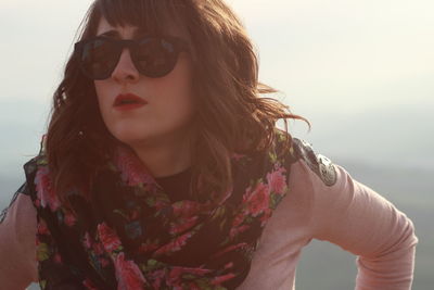 Woman wearing sunglasses and scarf