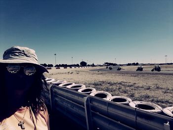 Rear view of woman on desert against clear sky