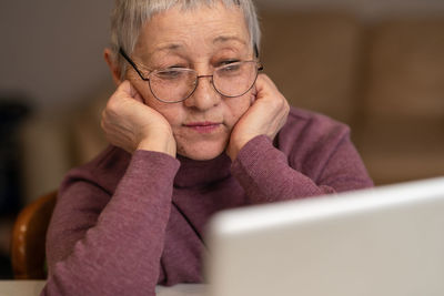 Young woman using laptop at home