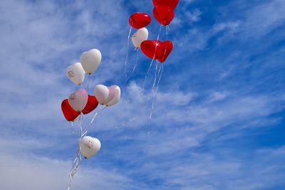 Low angle view of balloons against sky