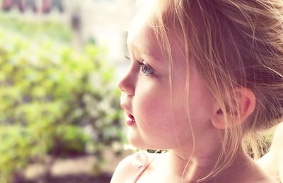 Close-up of cute thoughtful girl looking away