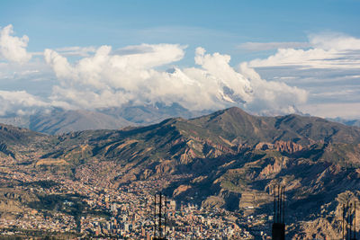 Aerial view of cityscape with mountains in background