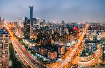 High angle view of illuminated city buildings against sky