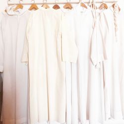 Close-up of white clothes hanging in store