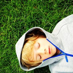 Portrait of cute girl lying on grass