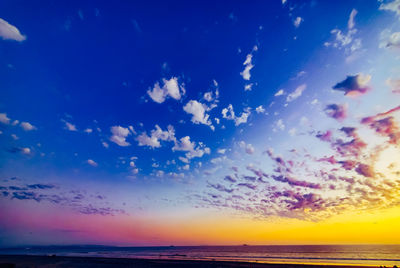 Scenic view of sea against dramatic sky during sunset