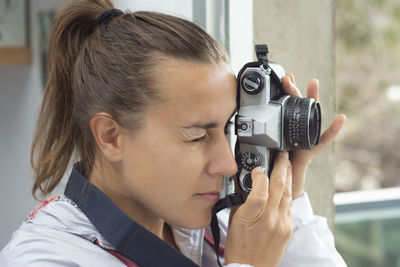 Portrait of woman photographing