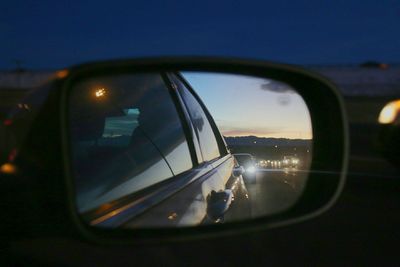 Reflection of car on side-view mirror