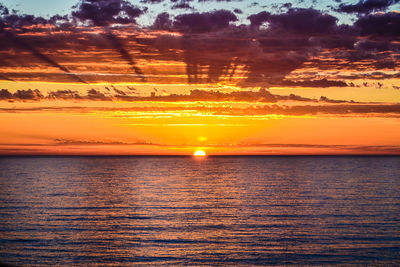 Scenic view of sea against romantic sky at sunset