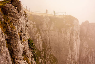 Scenic view of rocky mountains during foggy weather