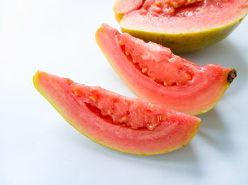 Close-up of strawberry on plate against white background