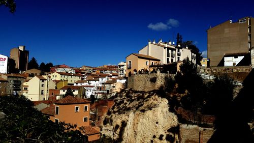 View of residential buildings against blue sky