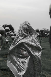 Rear view of man on field against sky