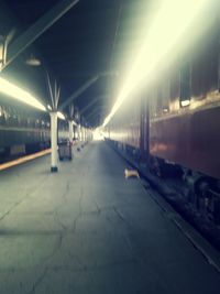 Illuminated railroad station against sky at night