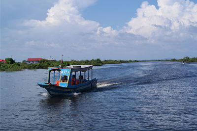 Boat sailing in sea against sky