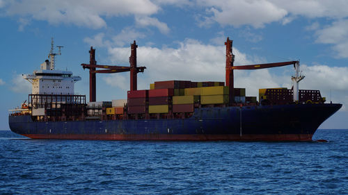 Commercial dock by sea against sky