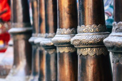 Close-up of cross on railing against building