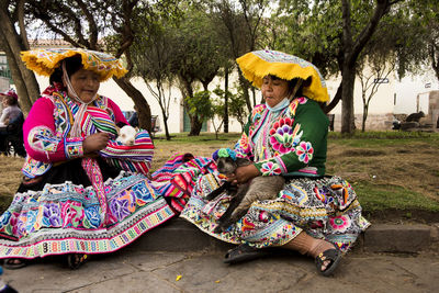 People sitting on multi colored tree