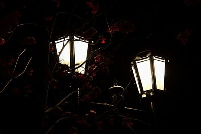 Low angle view of illuminated lamp in dark room