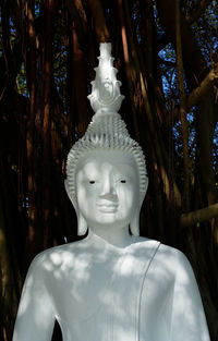 Statue of buddha against trees