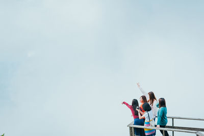 Group asian woman traveler open arms and embracing nature from top of mountain in spring season