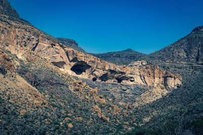 Scenic view of rocky mountains against clear blue sky