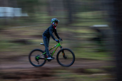 Full length of man riding bicycle