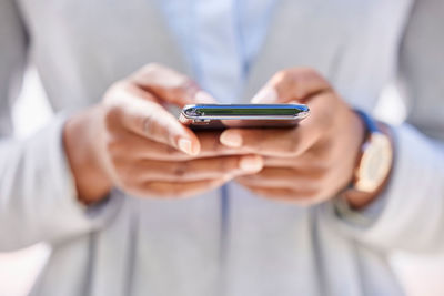 Midsection of woman using mobile phone