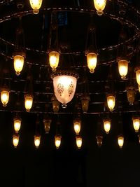 Low angle view of illuminated lanterns hanging at night