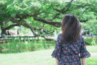 Rear view of woman standing in park