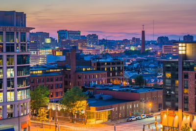 High angle view of illuminated buildings against sky at sunset