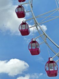 Low angle view of overhead cable car against sky