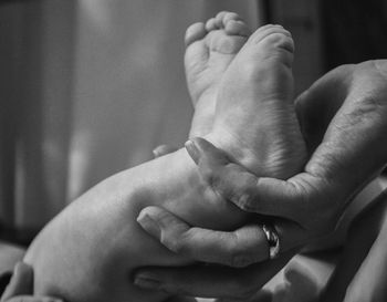 Close-up of hand holding feet