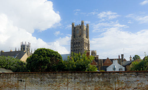 Buildings against cloudy sky