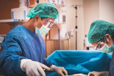 Surgeons performing surgery in operating room