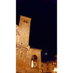 Low angle view of tower against sky at night