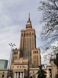 Low angle view of buildings against cloudy sky