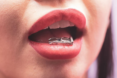 Close-up of small metal toy car in mouth