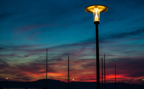 Low angle view of street light against sky at sunset