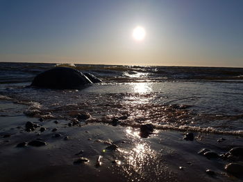 Scenic view of sea against clear sky during sunset