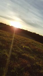 Scenic view of field against sky during sunset