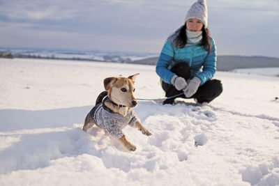 Full length of a dog on snow covered land