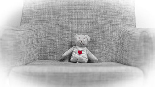 Boy sitting on sofa with toy
