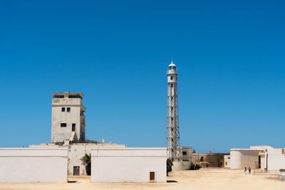 Low angle view of lighthouse against clear blue sky