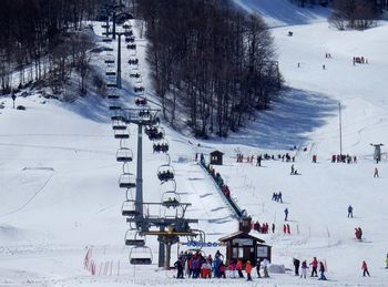 High angle view of people skiing on snow covered mountain