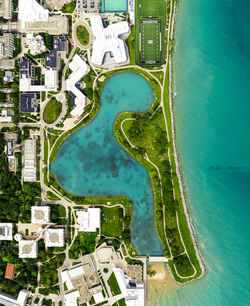 Aerial view of buildings in city by sea