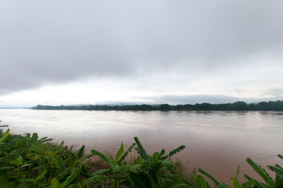 View of calm sea against cloudy sky