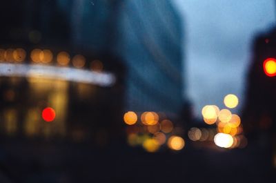 Defocused image of illuminated city street at night