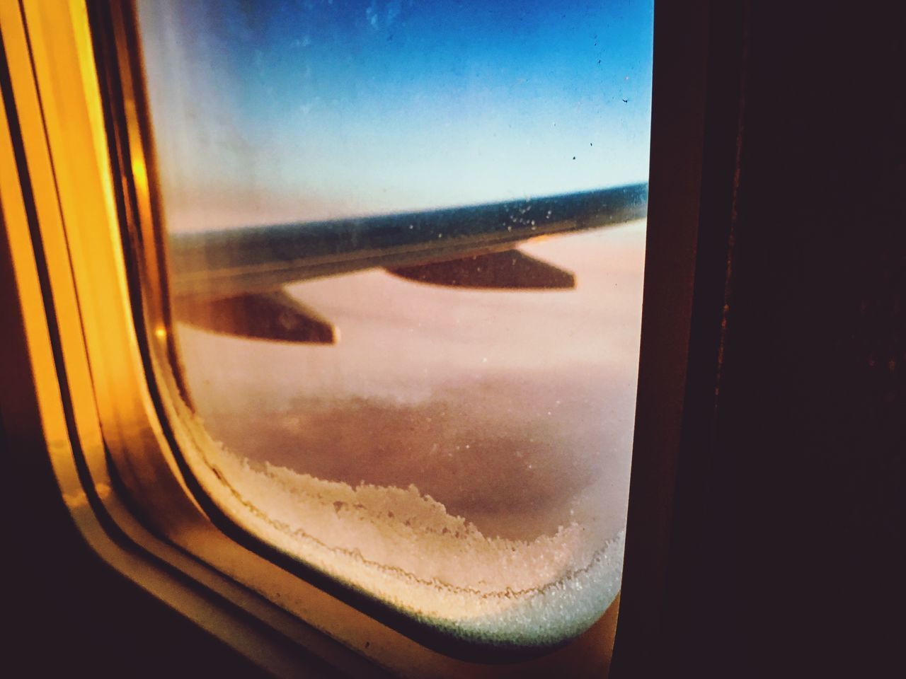 REFLECTION OF SKY SEEN THROUGH GLASS WINDOW OF AIRPLANE